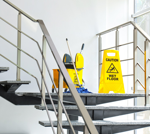 caution wet floor sign on office stairwell