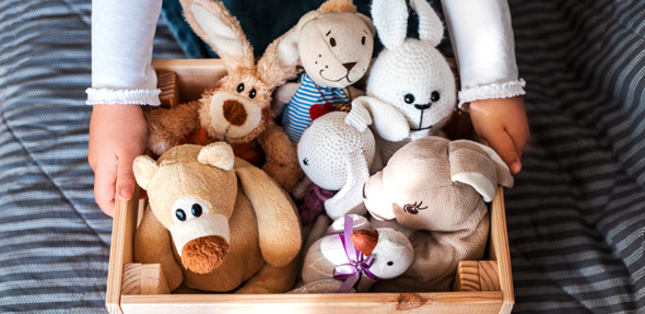 organised childs toy box of cuddly animals